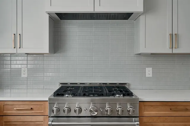 a stove top oven sitting inside of a kitchen