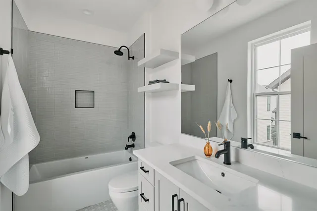 a bathroom with a sink a toilet and a tub