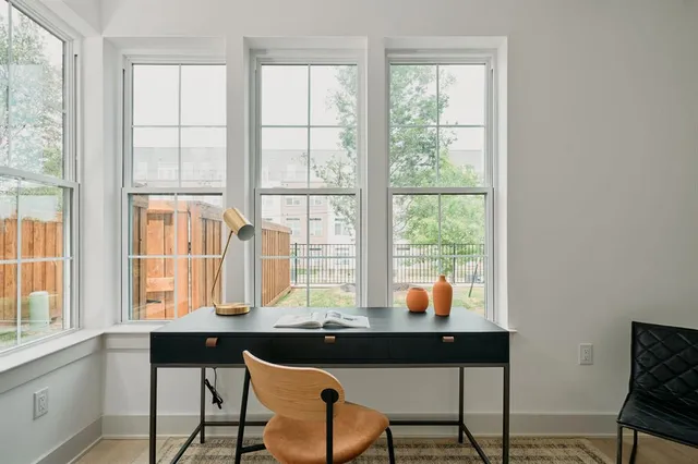 a table and chairs in a room with a window