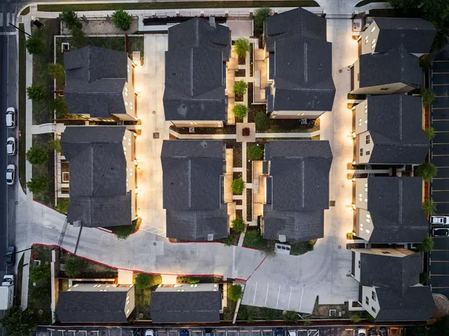 an aerial view of houses with outdoor space