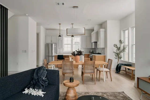 a large kitchen with a table and chairs