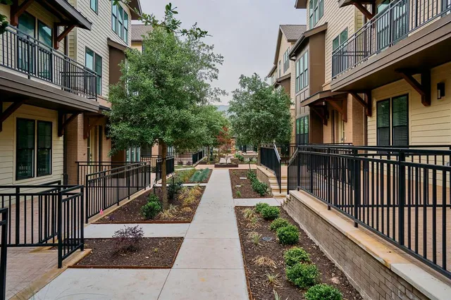 a view of a brick house with large windows