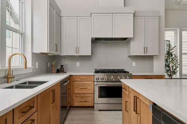 a kitchen with granite countertop white cabinets and white appliances