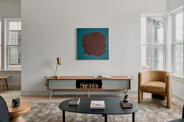 a living room with furniture and a chair