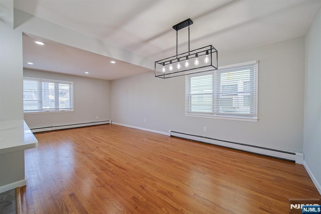 314 Garibaldi Avenue, Unit 1 Lodi, NJ 07644 - Photo 12 of 35 a view of an empty room with wooden floor and a window