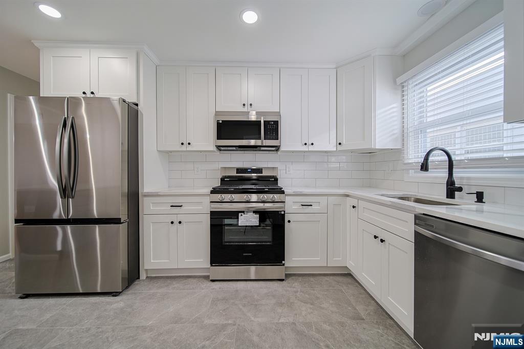 314 Garibaldi Avenue, Unit 1 Lodi, NJ 07644 - Photo 14 of 35 a kitchen with a refrigerator sink and microwave