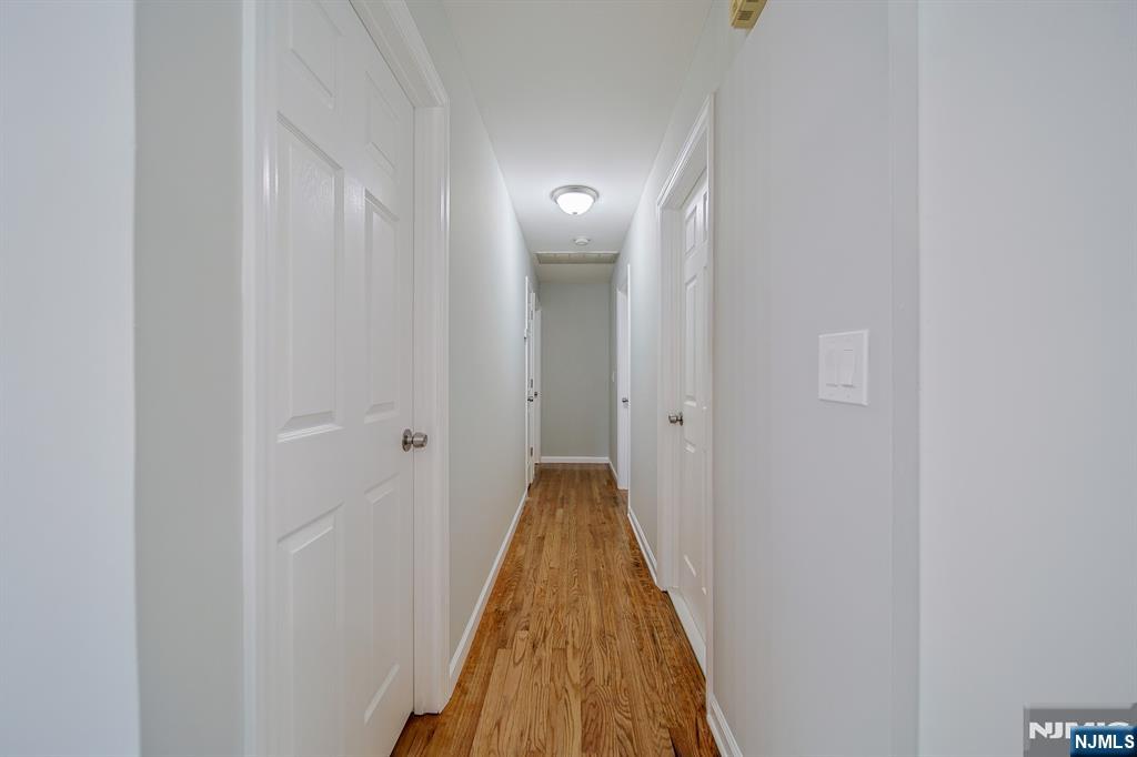 314 Garibaldi Avenue, Unit 1 Lodi, NJ 07644 - Photo 18 of 35 a view of a hallway with wooden floor and staircase