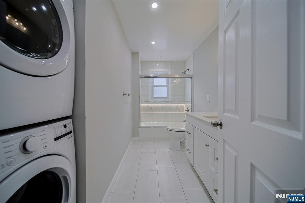 314 Garibaldi Avenue, Unit 1 Lodi, NJ 07644 - Photo 20 of 35 a hallway with a washer and dryer