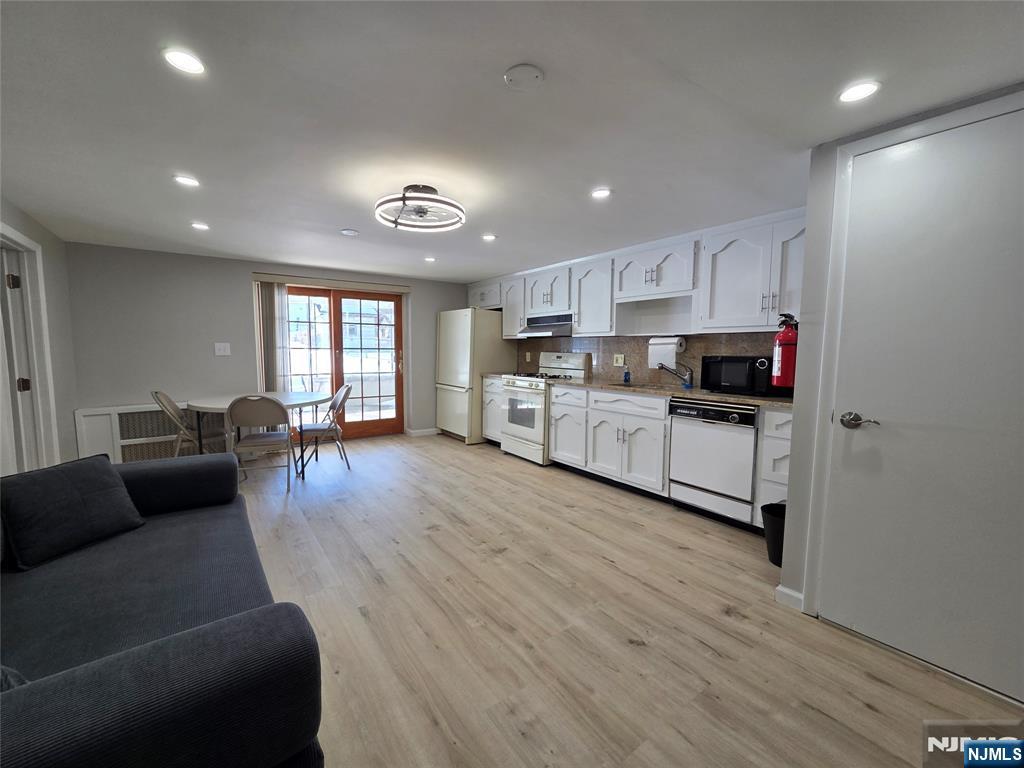 314 Garibaldi Avenue, Unit 1 Lodi, NJ 07644 - Photo 29 of 35 a living room with furniture and a wooden floor