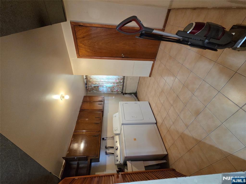 314 Garibaldi Avenue, Unit 1 Lodi, NJ 07644 - Photo 31 of 35 a large white room with a large mirror