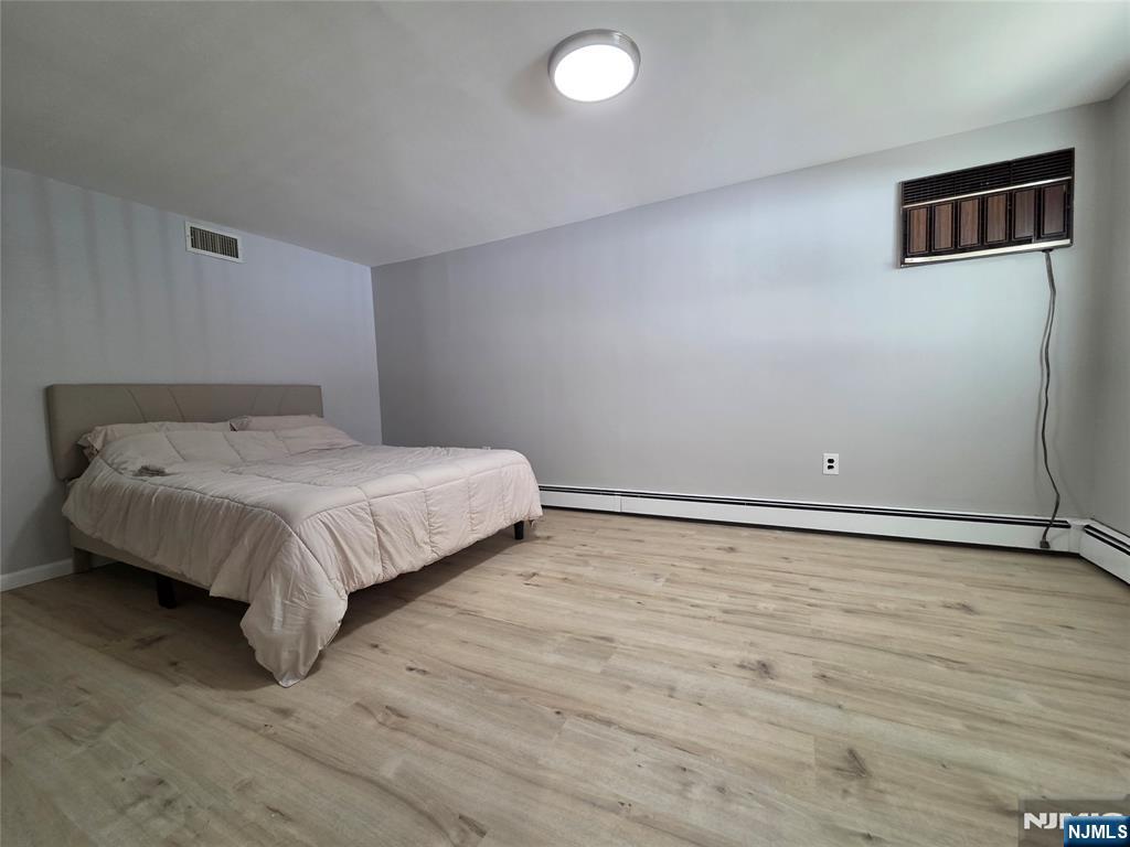 314 Garibaldi Avenue, Unit 1 Lodi, NJ 07644 - Photo 34 of 35 a large bed sitting in a room