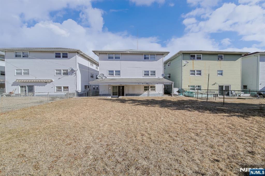 314 Garibaldi Avenue, Unit 1 Lodi, NJ 07644 - Photo 5 of 35 a front view of a house with a yard
