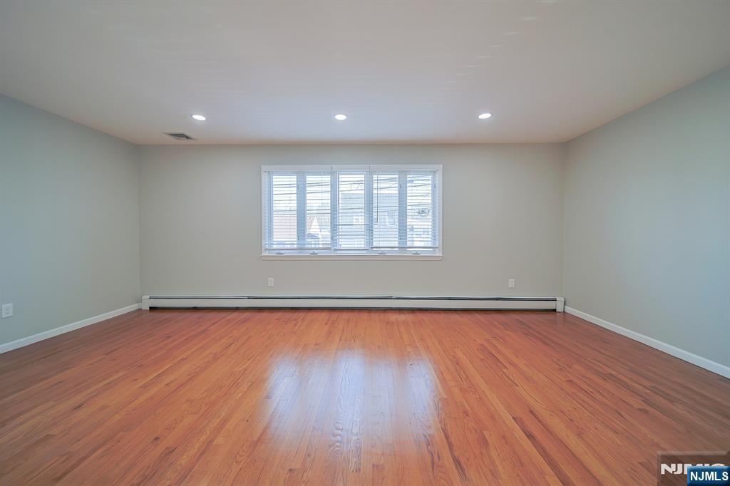 314 Garibaldi Avenue, Unit 1 Lodi, NJ 07644 - Photo 8 of 35 a view of a room with wooden floor and window