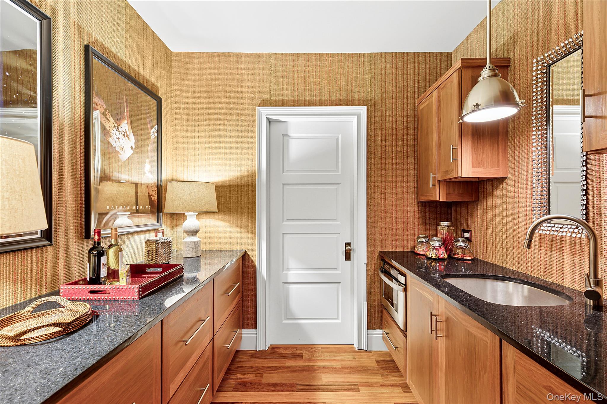 19 Ridge Lane Miller Place, NY 11764 - Photo 20 of 28 Kitchen featuring dark stone countertops, light wood-style flooring, hanging light fixtures, oven, and brown cabinetry