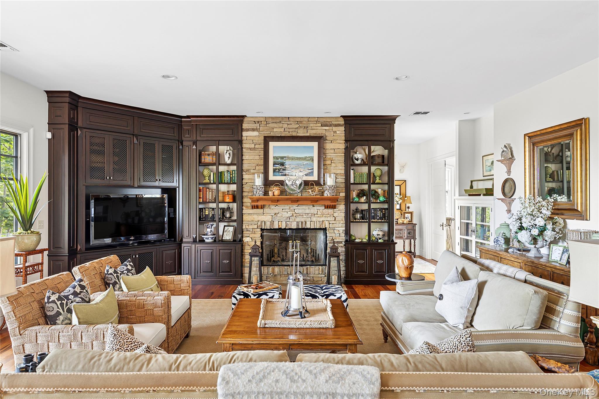 19 Ridge Lane Miller Place, NY 11764 - Photo 7 of 28 Living area featuring wood finished floors, a stone fireplace, and recessed lighting