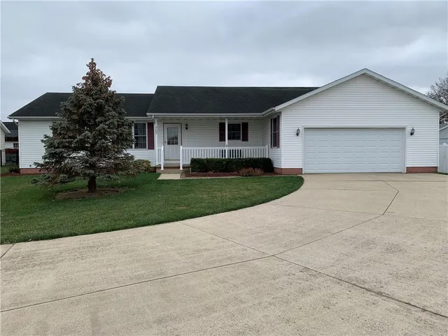 a front view of house with yard and green space