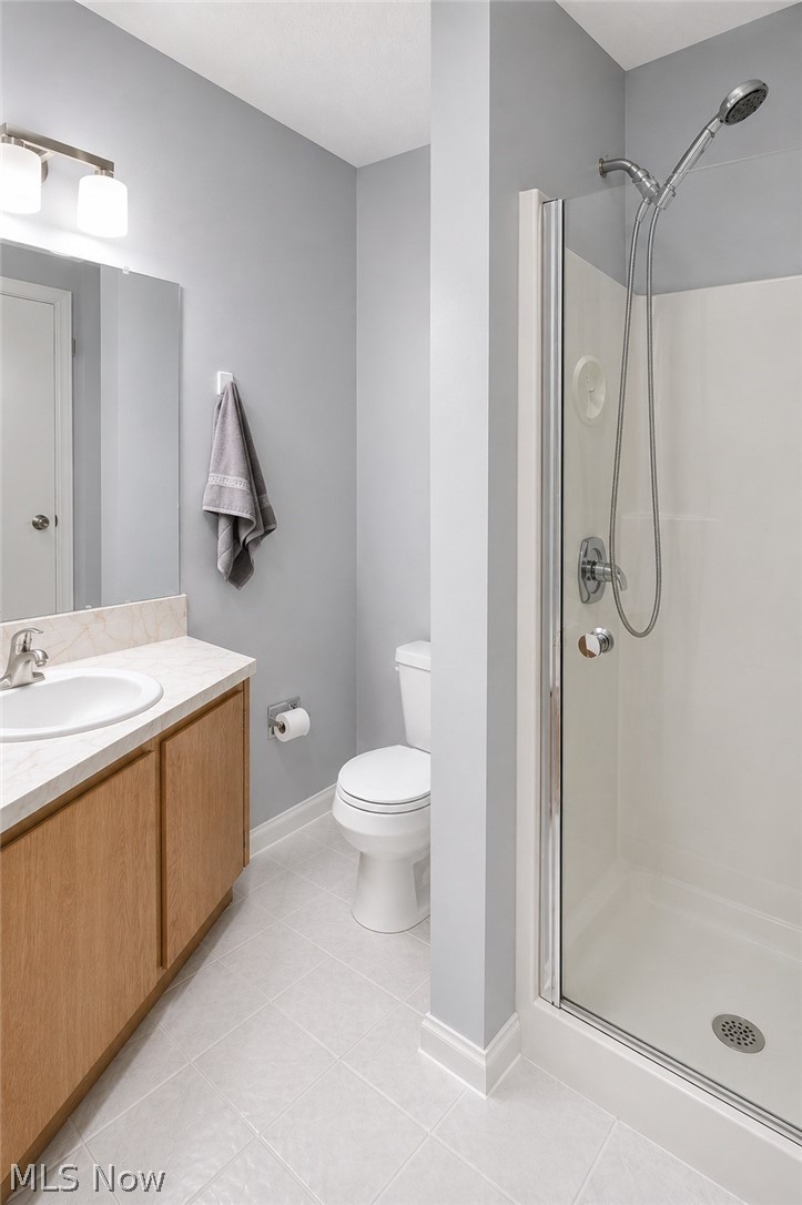 16575 Wren Road, Unit 3C Chagrin Falls, OH 44023 - Photo 17 of 29 Updated with a modern frameless glass enclosed shower with a handheld showerhead