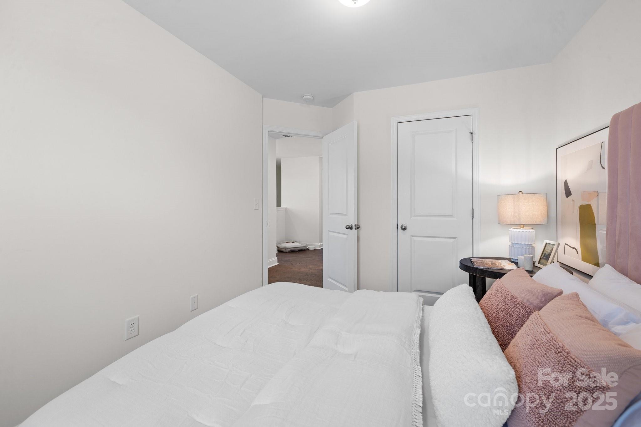 2919 Herringbone Road, Unit 39 Charlotte, NC 28208 - Photo 16 of 22 a bedroom with a bed and a lamp