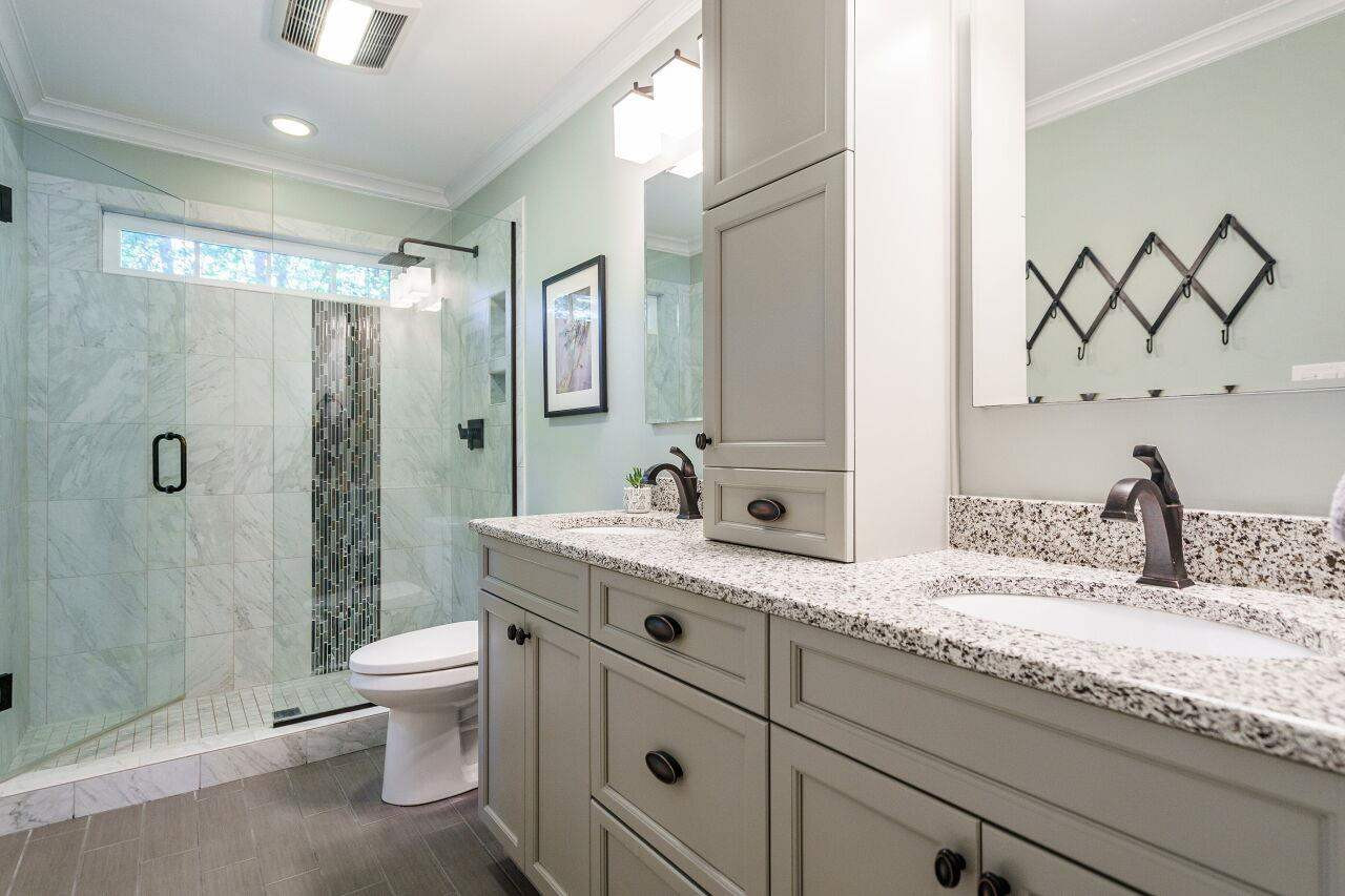 11000 Coachmans Way Raleigh, NC 27614 - Photo 18 of 30 Updated Master Bath with new cabinets, granite tops, fixtures, custom walk in shower with rain shower head, glass door and tile floors. Master Bath