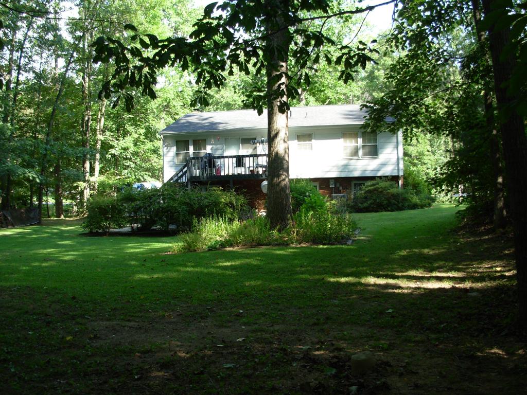 63 Cedarbrook Lane Blue Ridge, VA 24064 - Photo 2 of 14 a front view of a house with a garden