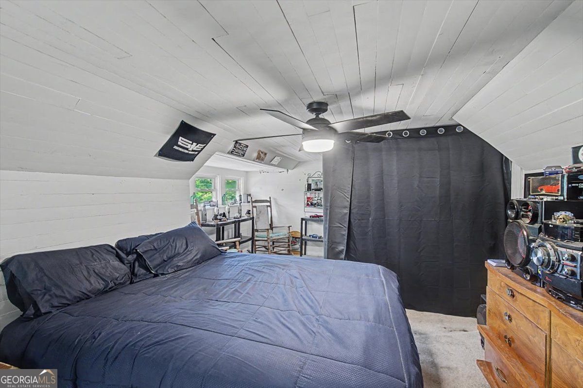 483 Coal Road Northwest Resaca, GA 30735 - Photo 33 of 56 a spacious bedroom with a bed and a chandelier