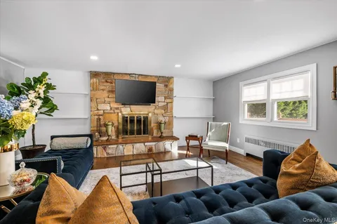 a living room with furniture a fireplace and a flat screen tv