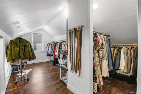 a view of walk in closet with clothes and shoes