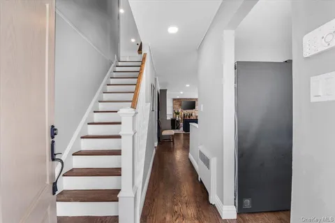 a view of a hallway with wooden floor and entryway