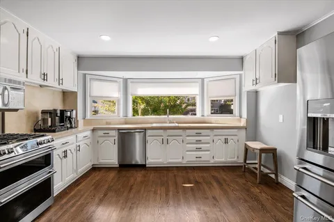 a kitchen with a stove a sink and a refrigerator