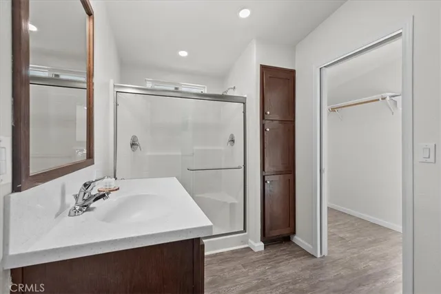 a bathroom with a shower sink vanity and mirror