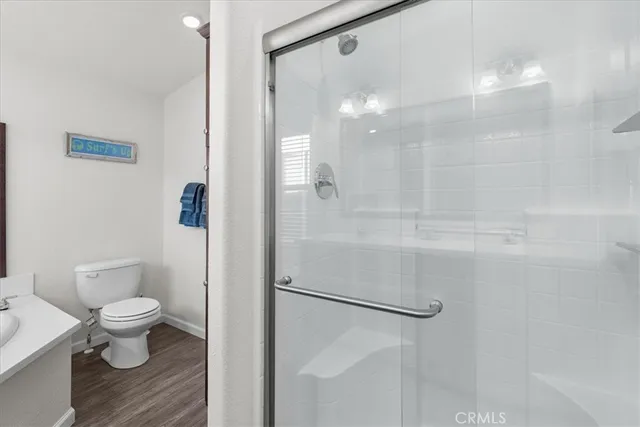 a view of a hallway with wooden floor and a livingroom view