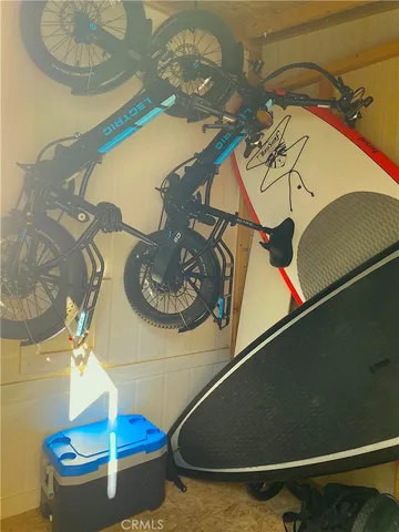 a view of a hallway with wooden floors and white walls