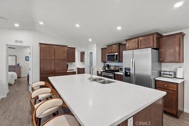 a kitchen with stainless steel appliances granite countertop a refrigerator stove and microwave