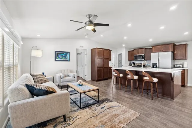 a bedroom with a large bed and a ceiling fan