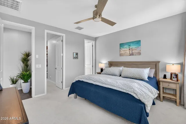 a bedroom with a large bed and a chandelier