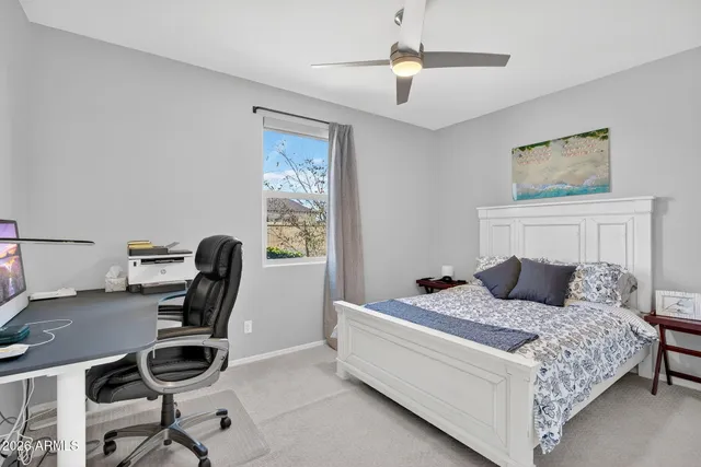 a bedroom with a bed and a desk