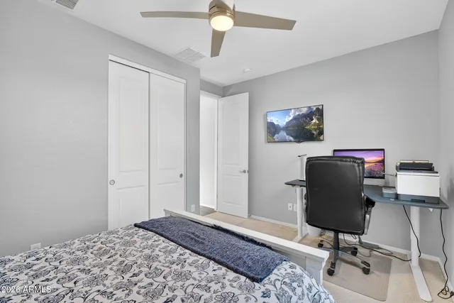 a bedroom with a bed and a chair