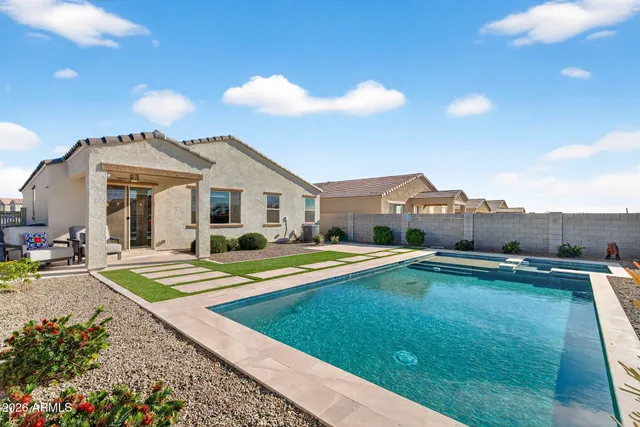 a view of a house with pool and a yard