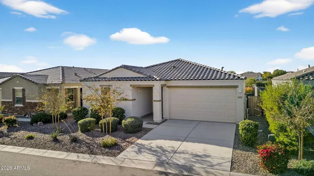 a aerial view of a house with table and chairs under an umbrella