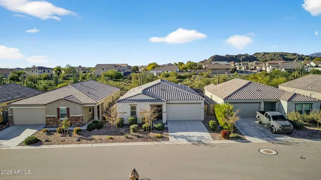 an aerial view of a house with table and chairs under an umbrella