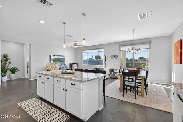 a kitchen with stainless steel appliances granite countertop a lot of cabinets a stove and a sink