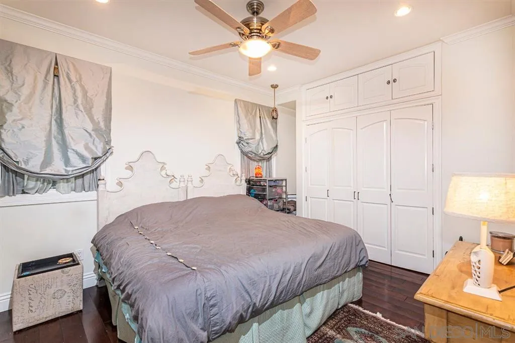 911 4th Street Coronado, CA 92118 - Photo 11 of 18 a bedroom with a bed and a chandelier