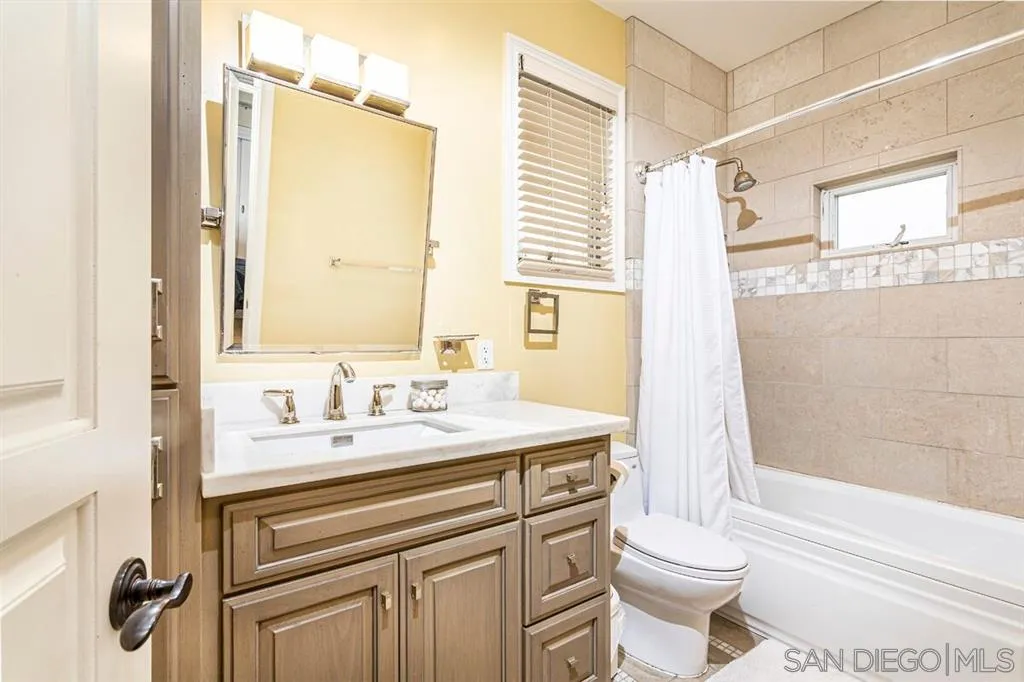 911 4th Street Coronado, CA 92118 - Photo 10 of 18 a bathroom with a sink toilet vanity and tub
