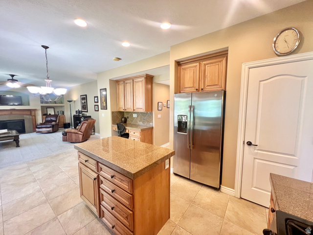 369 Culross Circle Tooele, UT 84074 - Photo 11 of 54 Kitchen island with stone-finish countertop and ample storage cabinetry