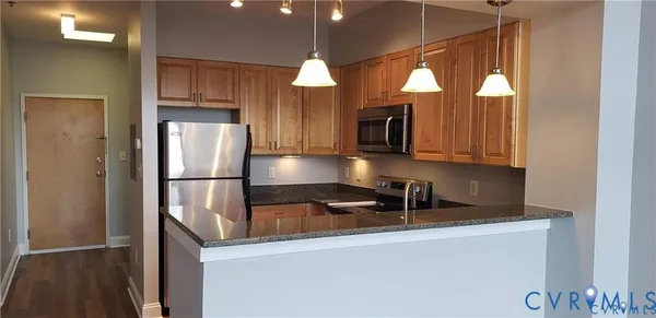 a kitchen with a refrigerator a microwave a sink and a stove