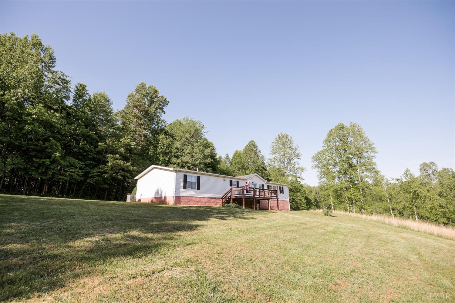 862 Snapps Mill Road Spout Spring, VA 24593 - Photo 2 of 29 a front view of a house with a yard and trees