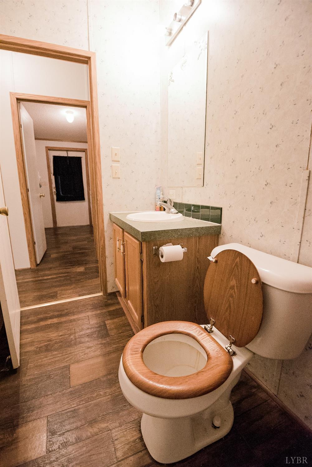 862 Snapps Mill Road Spout Spring, VA 24593 - Photo 22 of 29 a bathroom with a toilet a sink and mirror