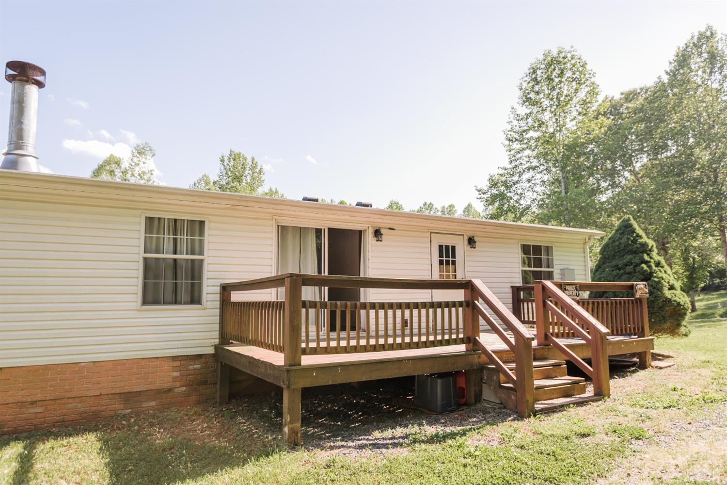 862 Snapps Mill Road Spout Spring, VA 24593 - Photo 27 of 29 a view of a house with a wooden deck and furniture