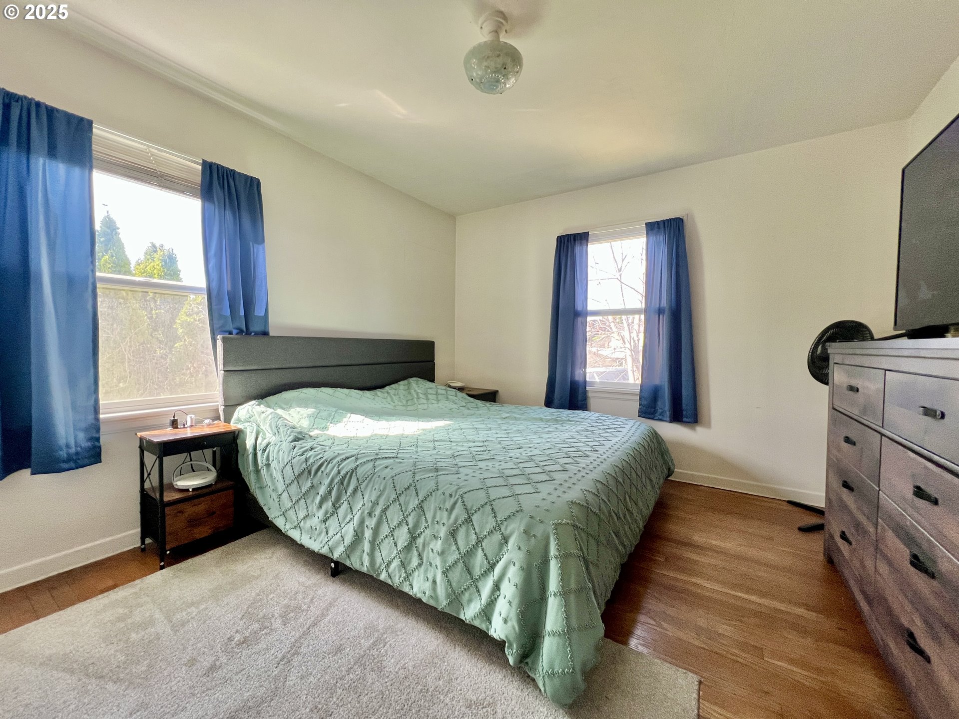 706 Northwest 10th Street Pendleton, OR 97801 - Photo 12 of 19 a bedroom with a bed and a flat tv screen on dresser
