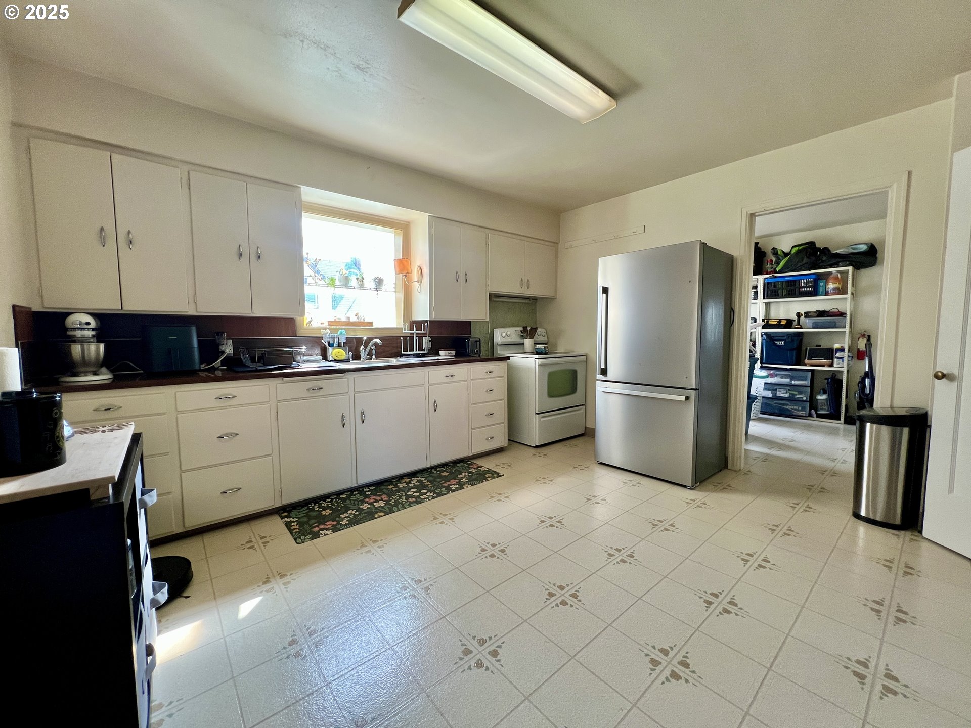 706 Northwest 10th Street Pendleton, OR 97801 - Photo 10 of 19 a kitchen with granite countertop a refrigerator and a stove top oven